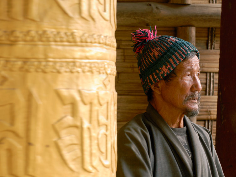A man and a prayer wheel SB06559-A-man-and-a-prayer-wheel.jpg