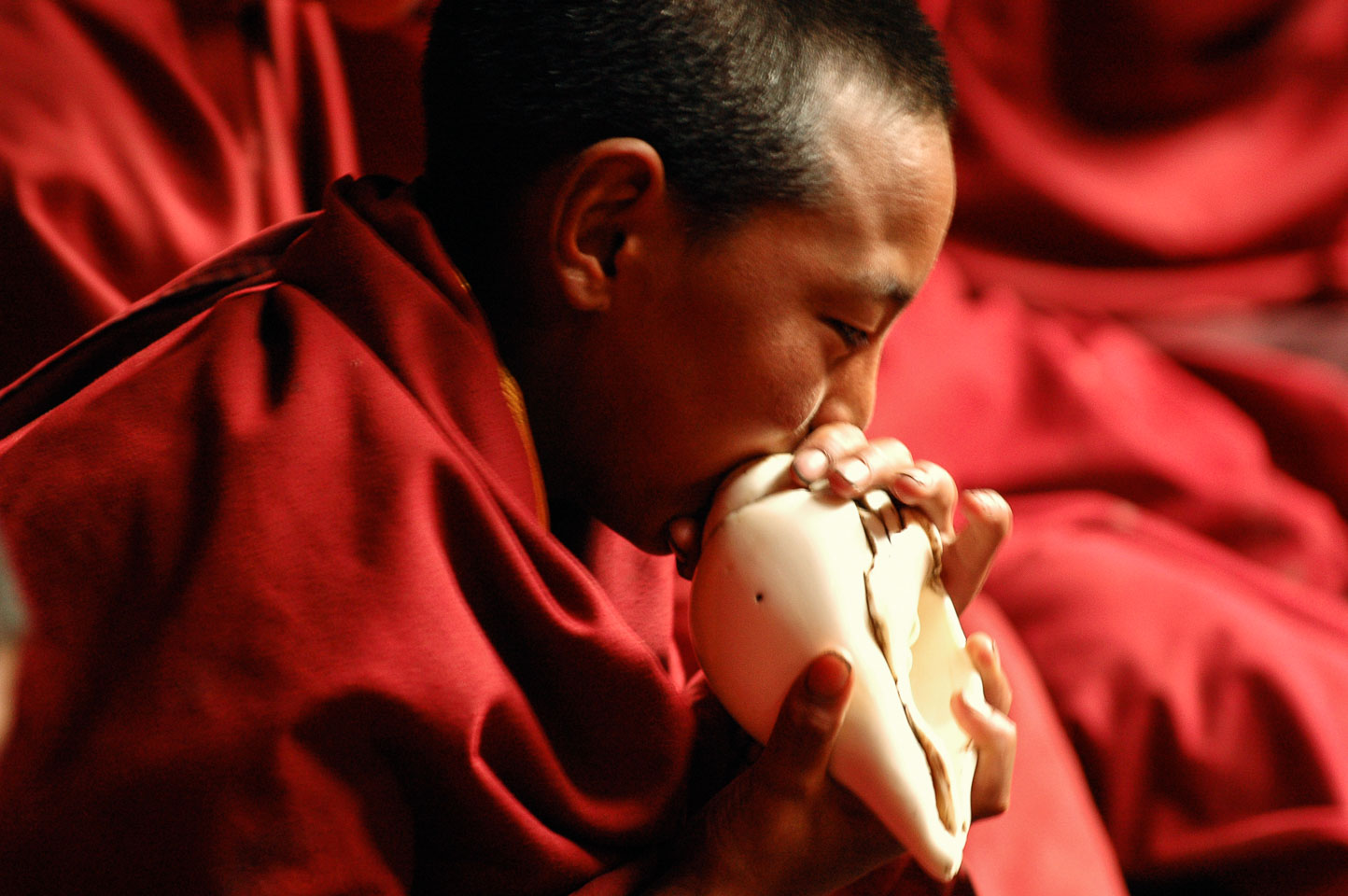 CN050525-Blowing-a-conch-shell-at-a-Monastery-in-Xiewu.jpg